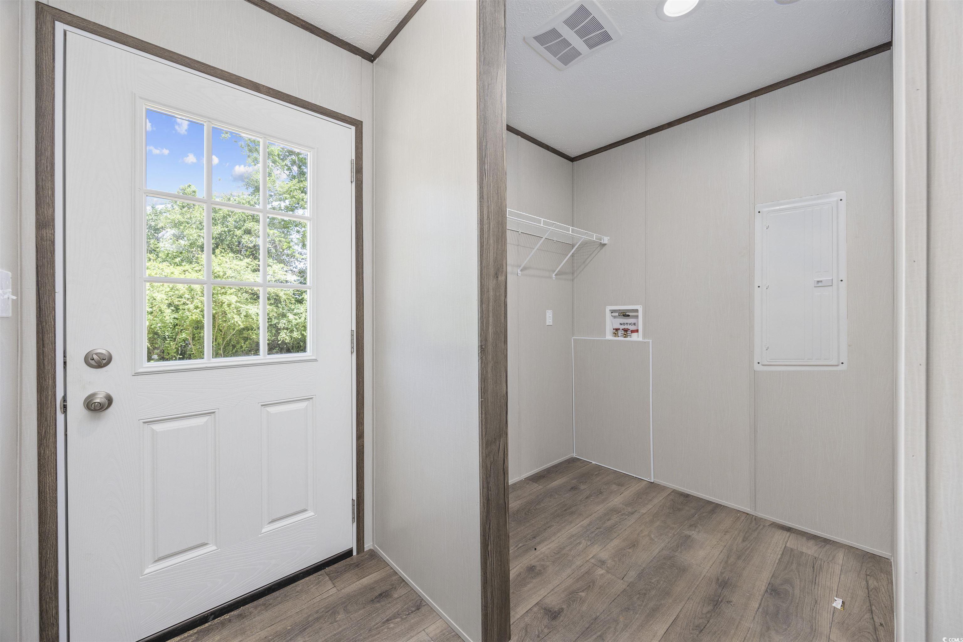 1315 Rabbit Lane Conway, SC 29526 - Photo 19 of 27 Laundry room featuring wood finished floors, electric panel, ornamental molding, and washer hookup