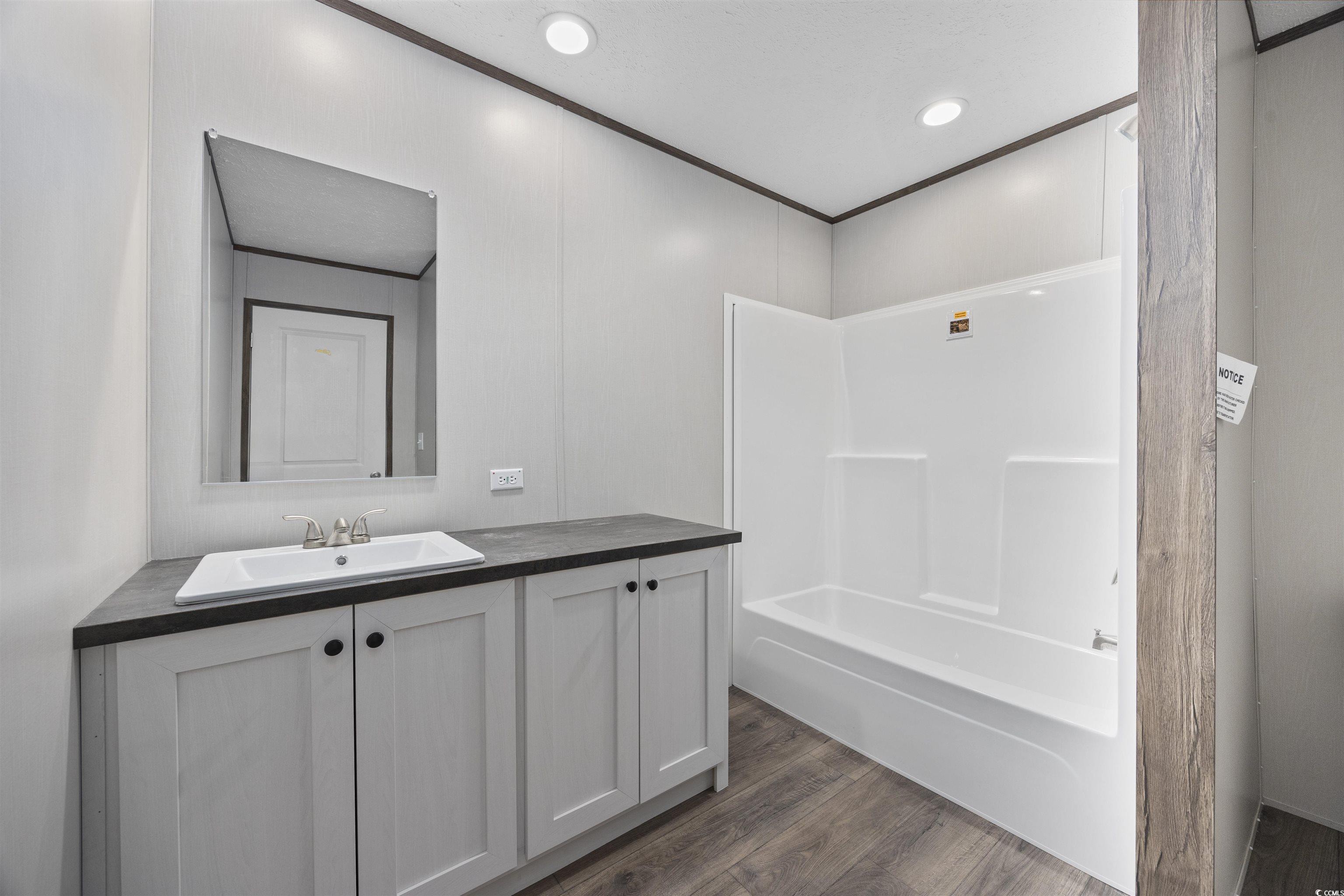1315 Rabbit Lane Conway, SC 29526 - Photo 21 of 27 Full bath with vanity, dark wood-style flooring, shower combination, crown molding, and recessed lighting