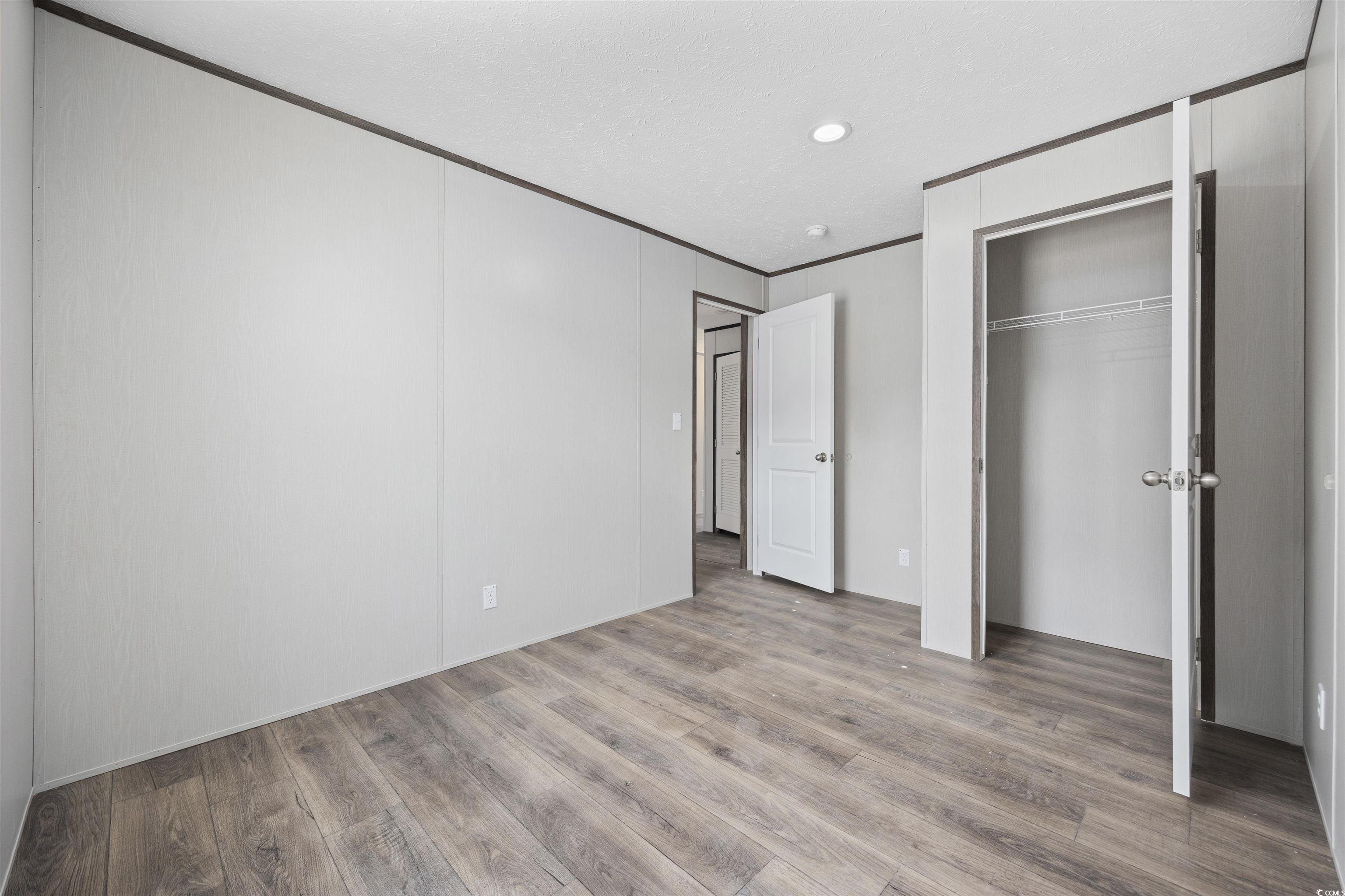 1315 Rabbit Lane Conway, SC 29526 - Photo 25 of 27 Unfurnished bedroom with wood finished floors, a closet, crown molding, and recessed lighting