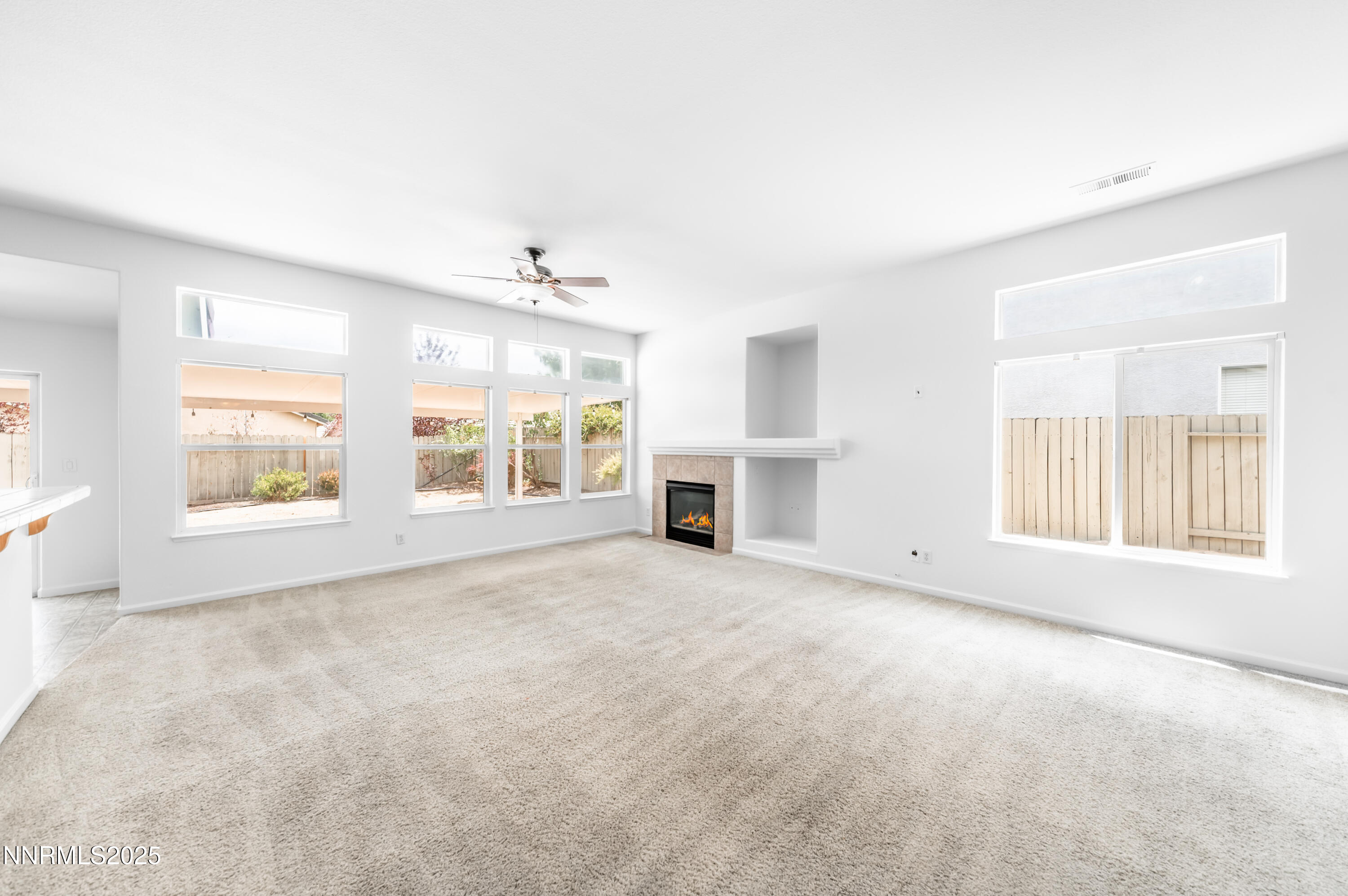 1260 Edgehill Court, Unit ARBOR Reno, NV 89521 - Photo 14 of 50 an empty room with windows and fireplace