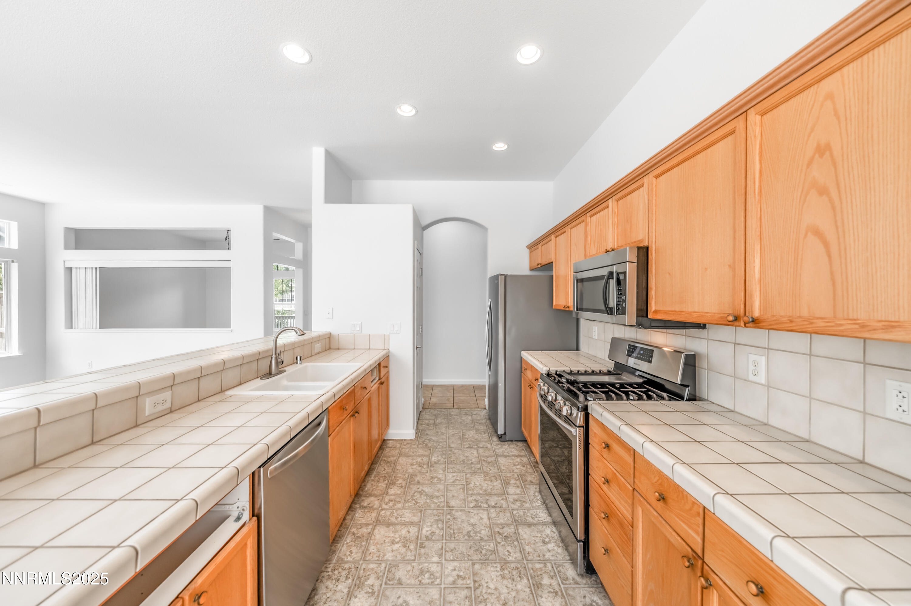 1260 Edgehill Court, Unit ARBOR Reno, NV 89521 - Photo 21 of 50 a kitchen with stainless steel appliances granite countertop a stove a sink and a refrigerator