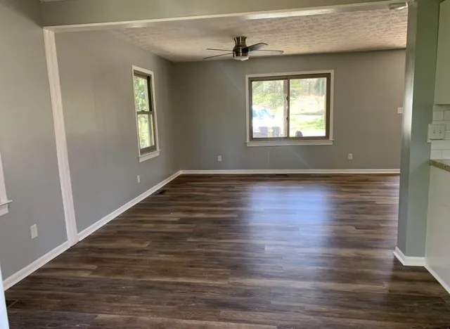 a bathroom with a granite countertop toilet and sink
