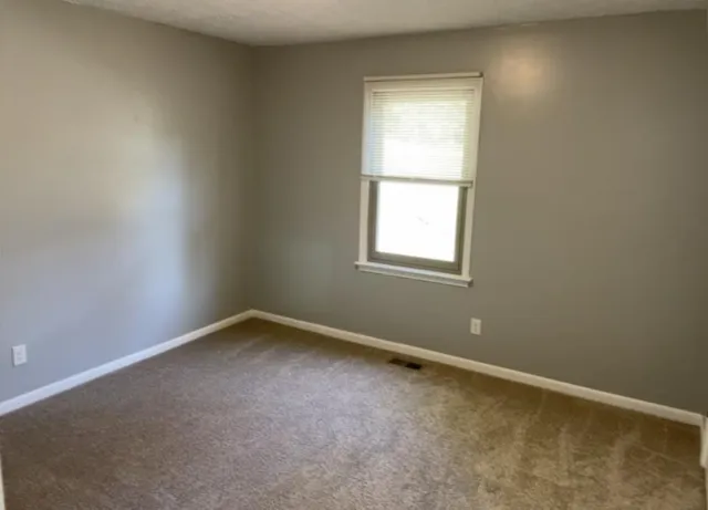 a spacious bathroom with a granite countertop sink toilet and shower