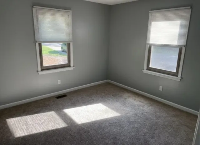 a bathroom with a granite countertop bathtub sink vanity mirror and toilet