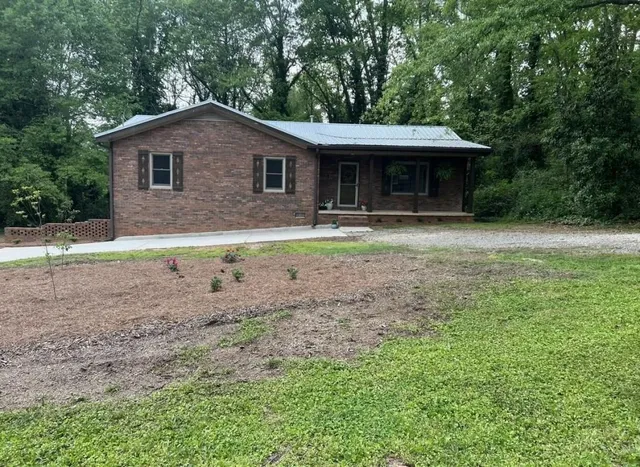 a front view of a house with a garden