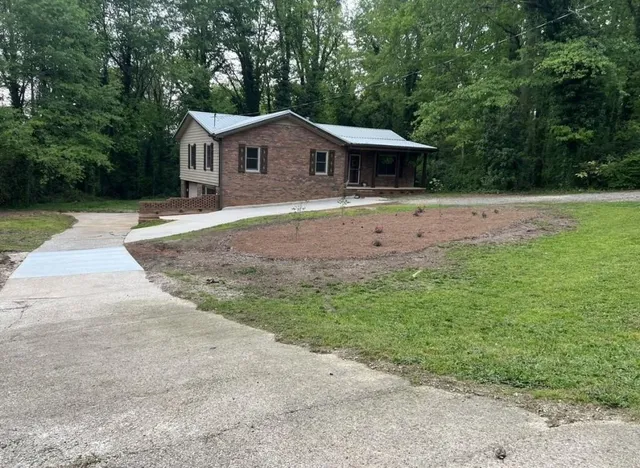 a front view of a house with a yard