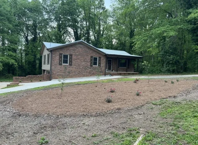 a front view of a house with garden