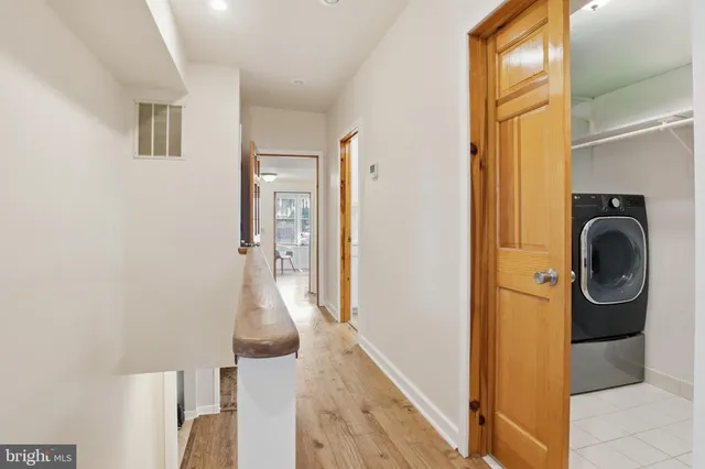 a view of a hallway with washer and dryer