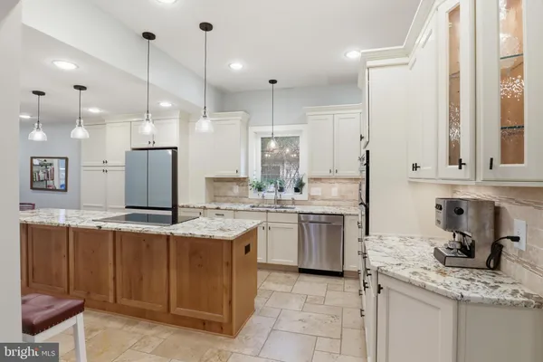 a kitchen with a sink refrigerator and cabinets