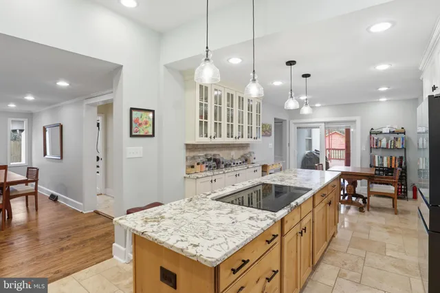 a kitchen with center island table and chairs
