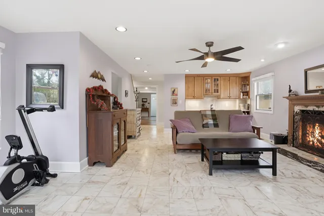 a living room with furniture gym equipment and a view of kitchen