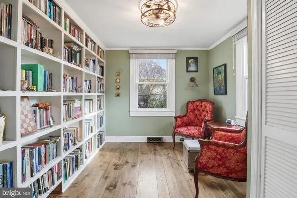 a living room with furniture toys and a book shelf