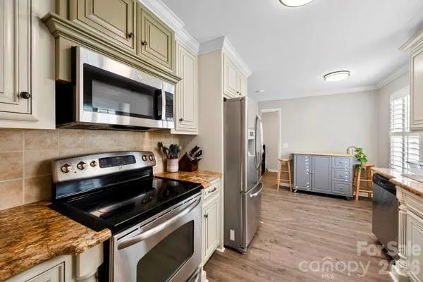 a kitchen with wooden cabinets and stainless steel appliances