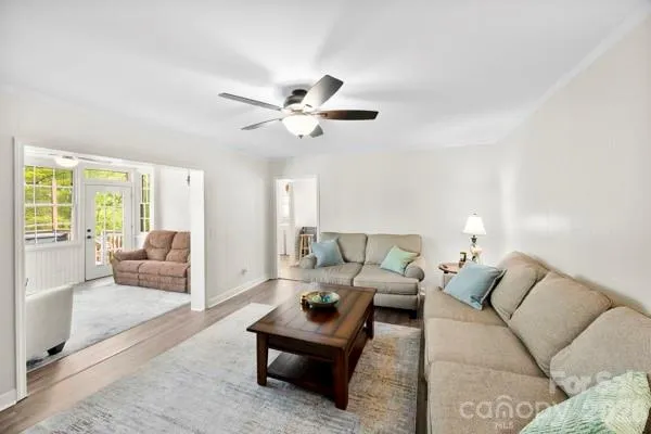 a living room with furniture and a chandelier