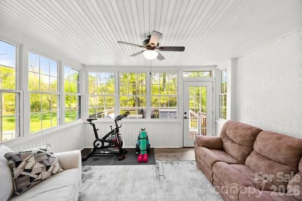 a living room with furniture and floor to ceiling windows
