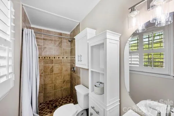 a bathroom with a toilet and shower
