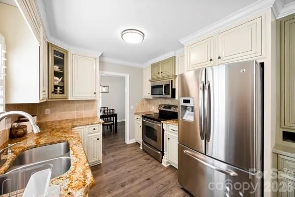 a kitchen with stainless steel appliances a refrigerator stove and sink