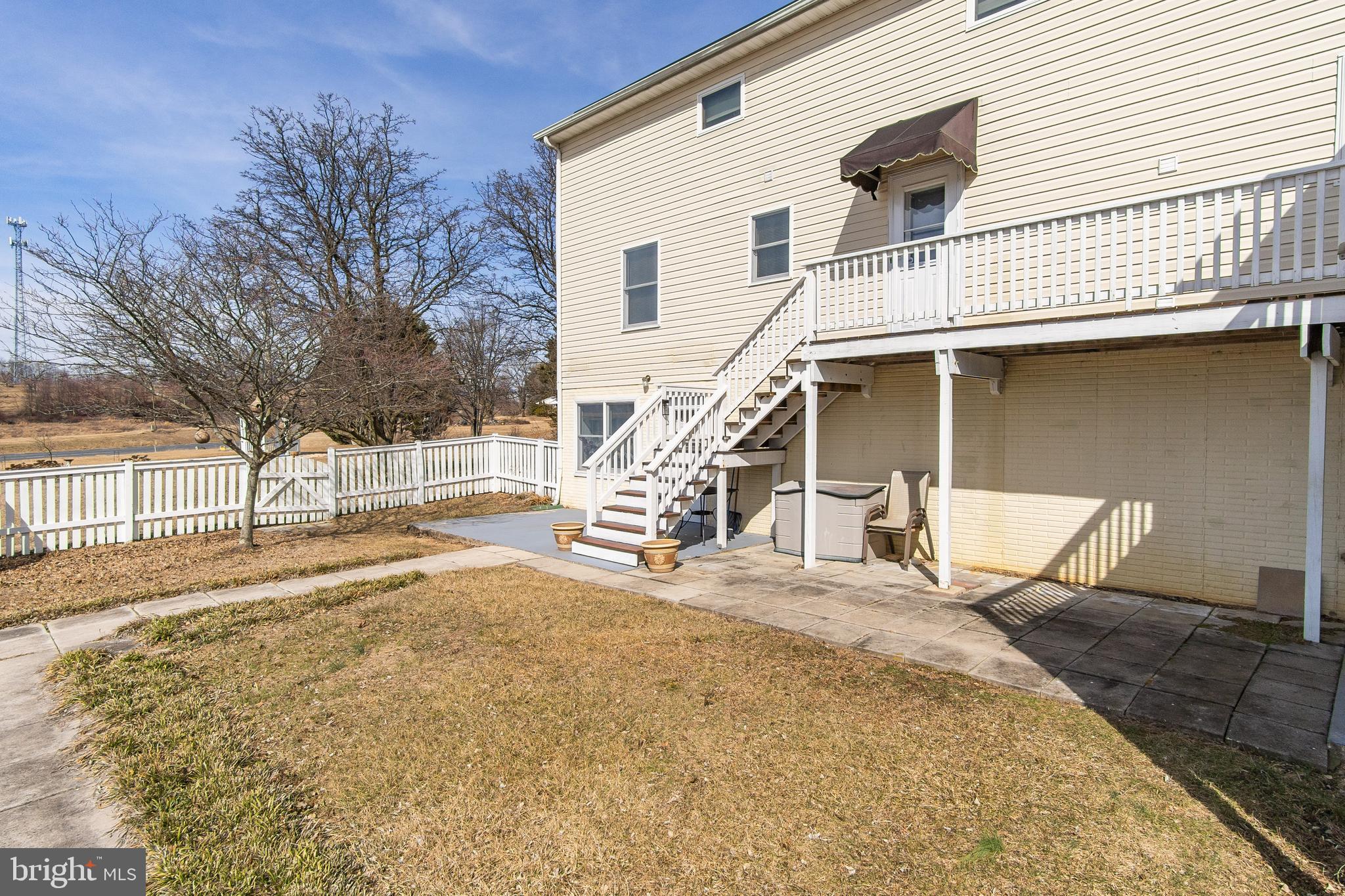 13810 Franks Run Road Smithsburg, MD 21783 - Photo 52 of 72 a backyard of a house with large trees and outdoor seating
