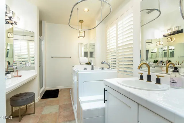a bathroom with a sink and a mirror with toilet