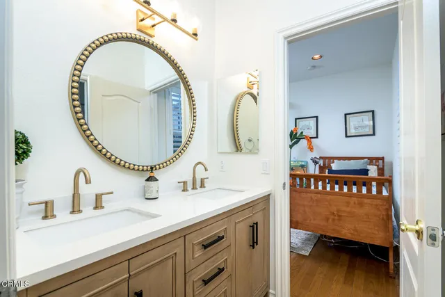 a spacious bathroom with a double vanity sink and a mirror