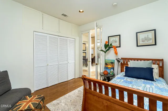 a bedroom with a bed and glass door