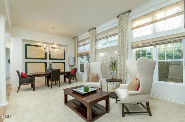 a living room with furniture and a floor to ceiling window