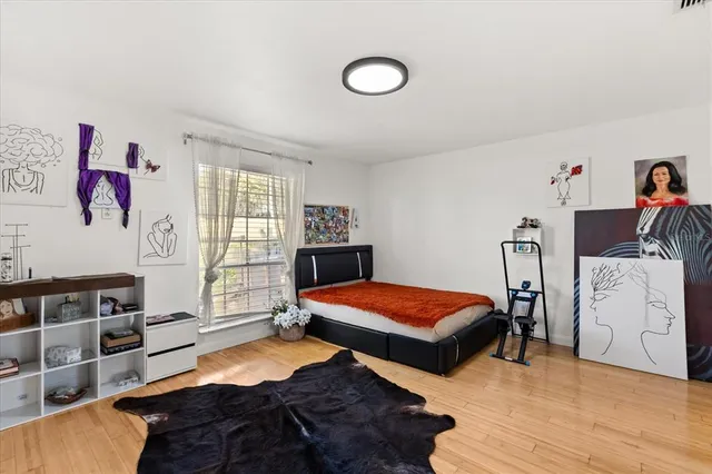 a bedroom with two beds and a window