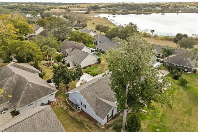 an aerial view of residential houses with outdoor space and swimming pool