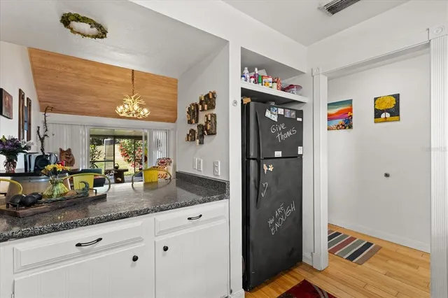 a bathroom with a granite countertop sink a mirror and shower