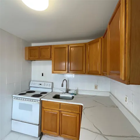 a kitchen with a sink cabinets and a window