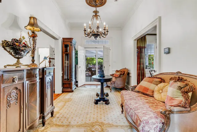 a living room with furniture a rug and a large window