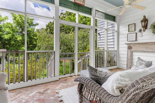 a hallway with fireplace and chandelier