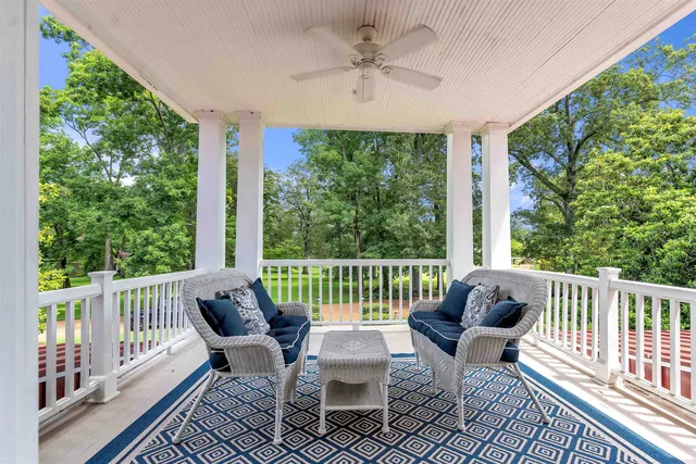 a bedroom with furniture and a chandelier