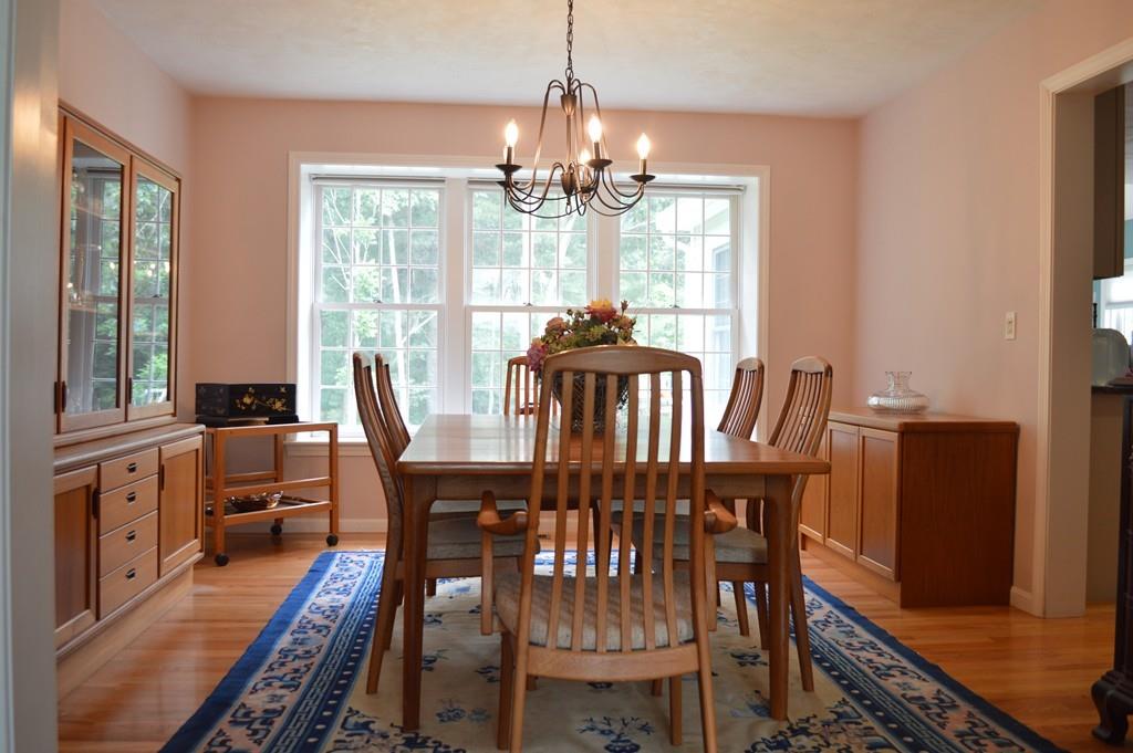 9 Windmill Hill Road Stow, MA 01775 - Photo 4 of 22 a view of a dining room with furniture a chandelier and wooden floor