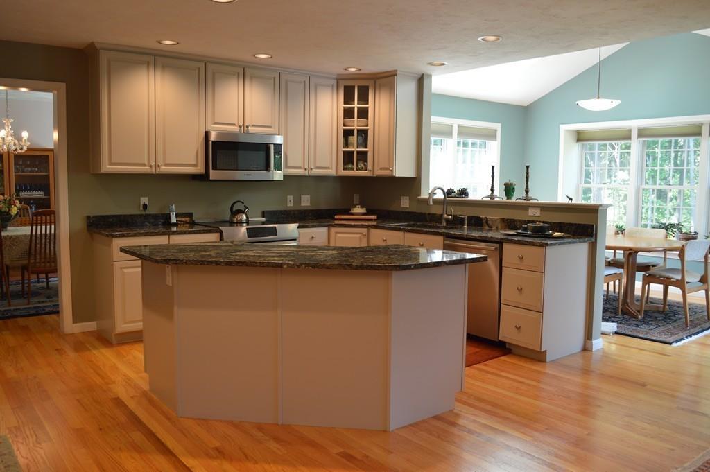 9 Windmill Hill Road Stow, MA 01775 - Photo 5 of 22 a kitchen with kitchen island granite countertop a sink a stove top oven a counter space and cabinets