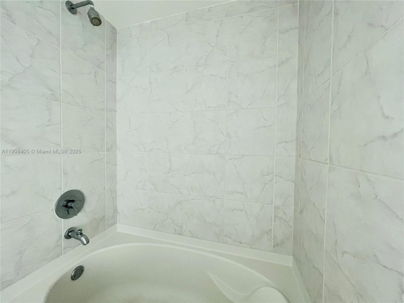 951 Brickell Avenue, Unit 2407 Miami, FL 33131 - Photo 13 of 19 a bathroom with a bathtub