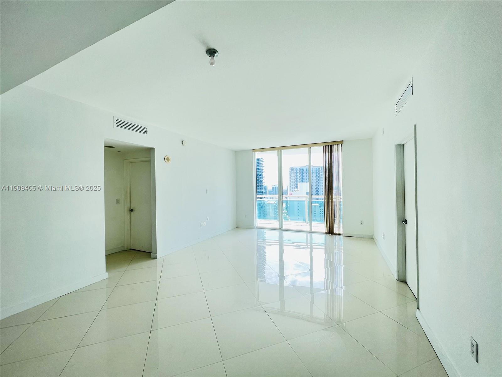 951 Brickell Avenue, Unit 2407 Miami, FL 33131 - Photo 2 of 19 a view of an empty room with glass door