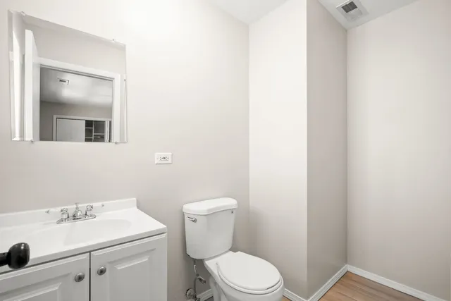 a white toilet sitting next to a bathroom sink