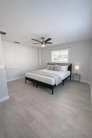 a bed room with a bed and window