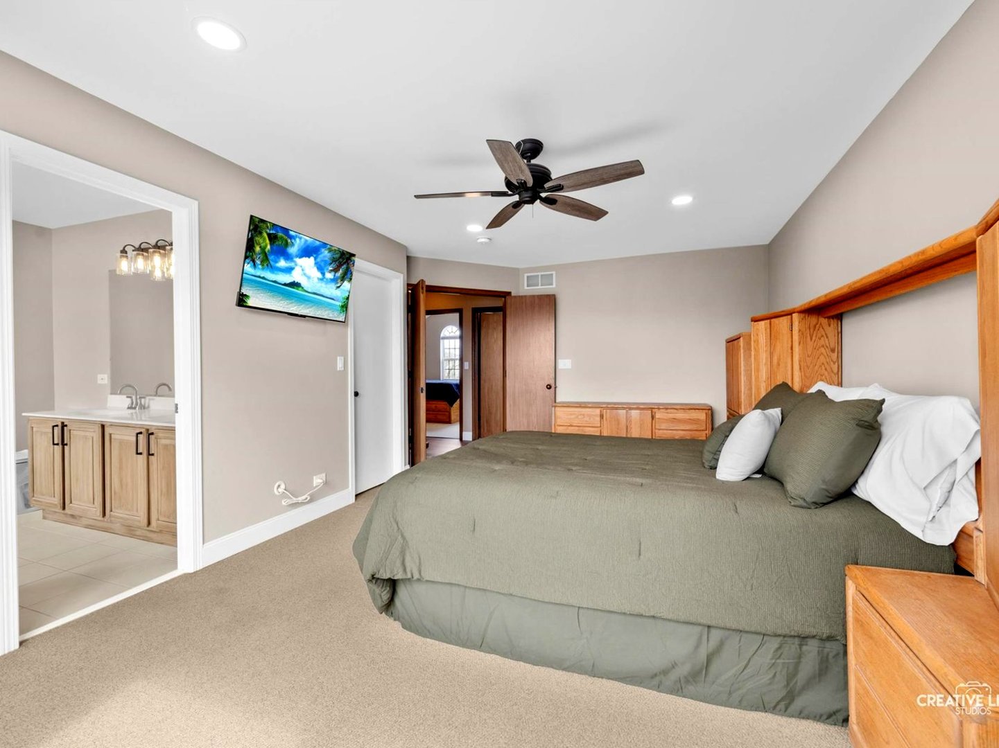 1524 West Mooseheart Road North Aurora, IL 60542 - Photo 12 of 32 a bedroom with a large bed and a ceiling fan