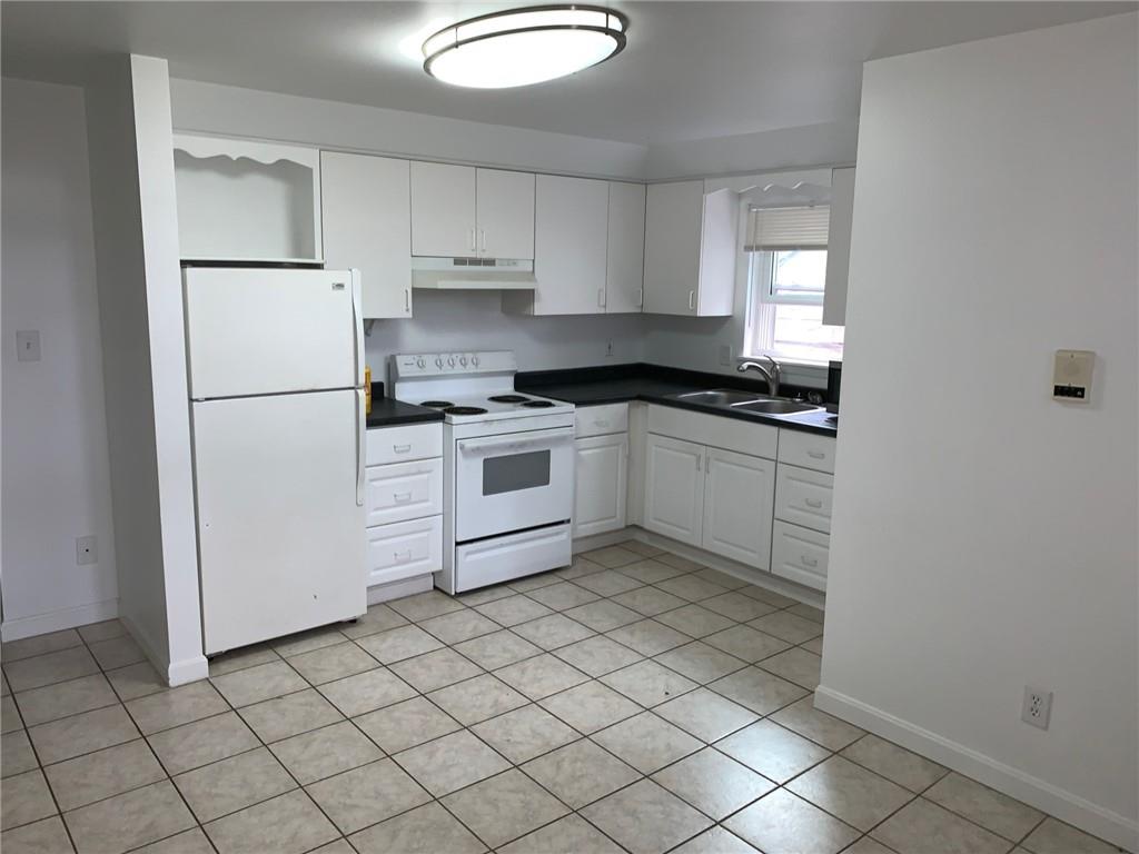 5144 Butler Street Pittsburgh, PA 15201 - Photo 17 of 20 a kitchen with white cabinets stainless steel appliances and a sink