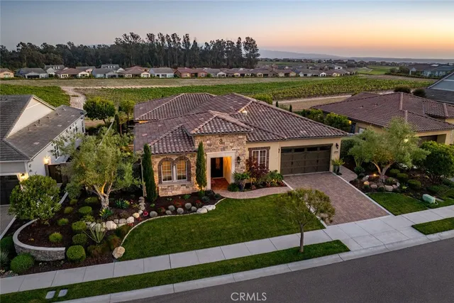 an aerial view of a house with garden space and lake view