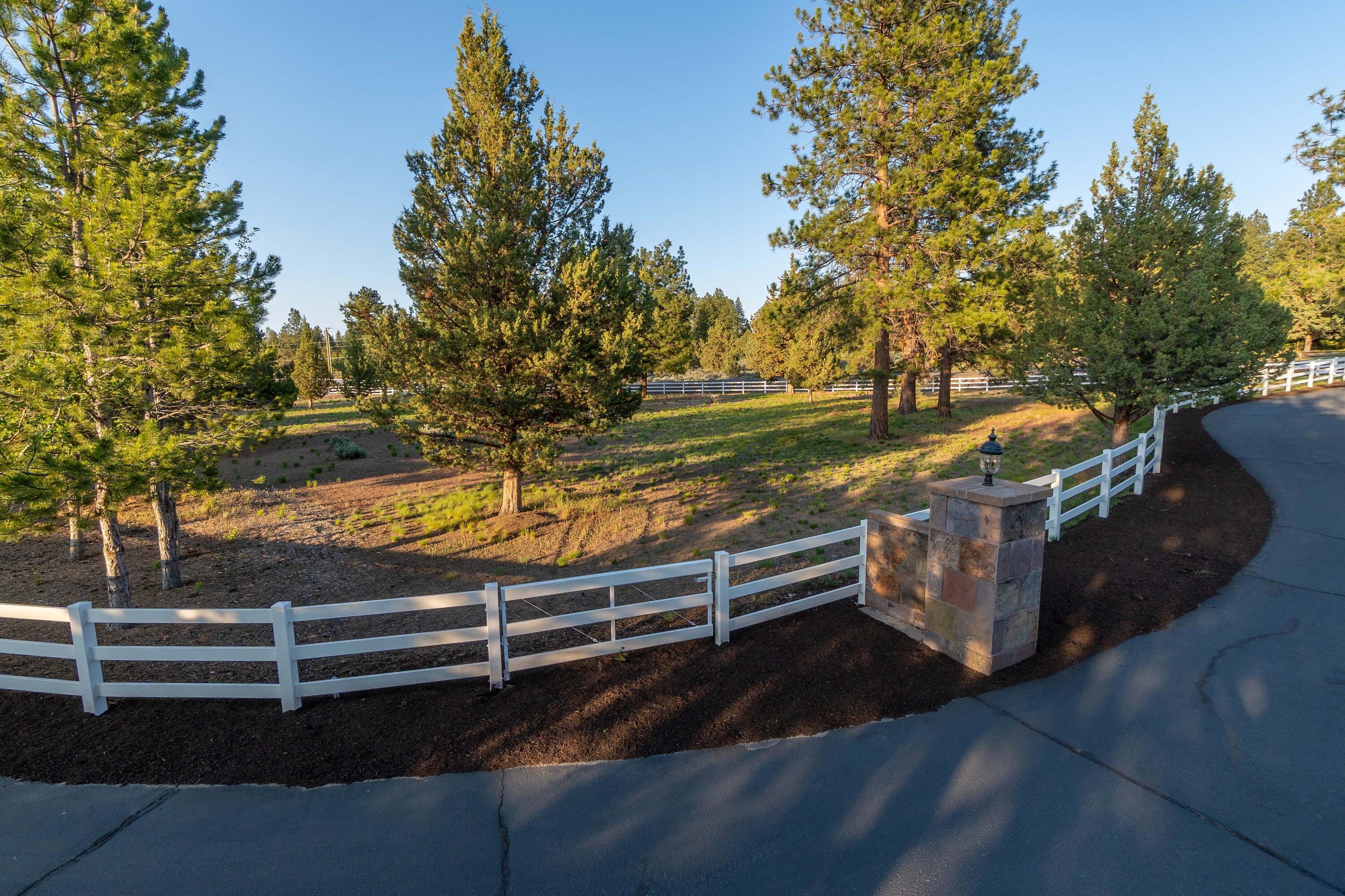 60485 Billadeau Road Bend, OR 97702 - Photo 38 of 47 Paved Driveway with Ornamental Pillars and fenced pasture