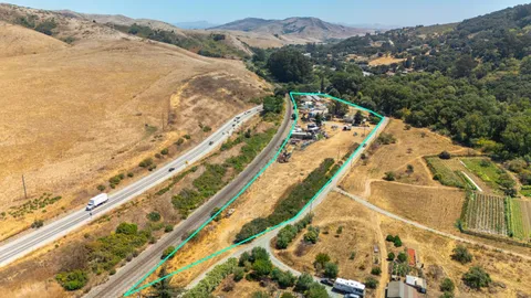 a view of a large white building with a mountain
