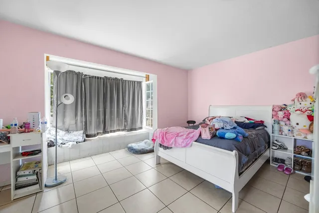 a bedroom with a bed and a window