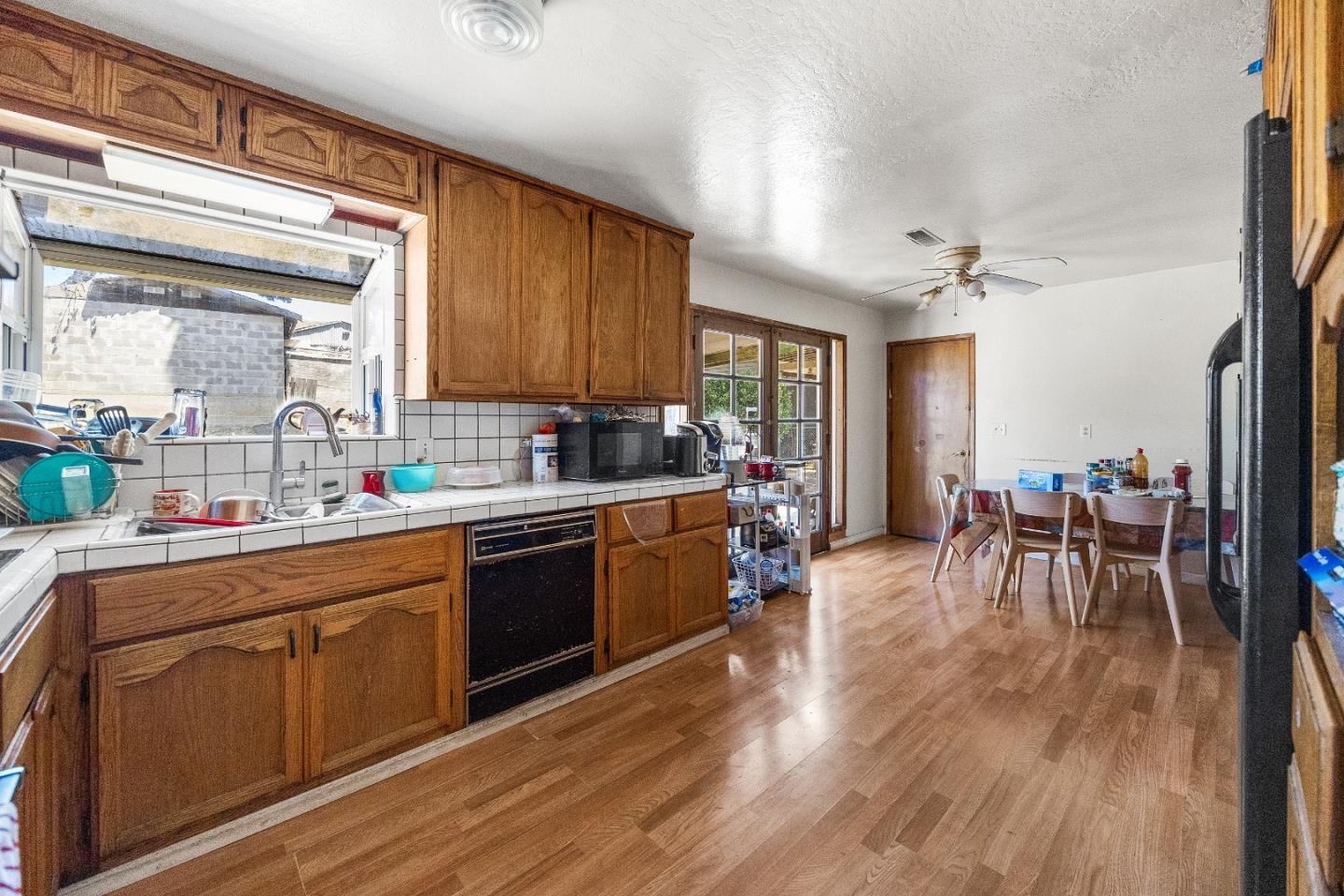 250 Old Chittenden Road Watsonville, CA 95076 - Photo 7 of 24 a kitchen with sink cabinets and wooden floor