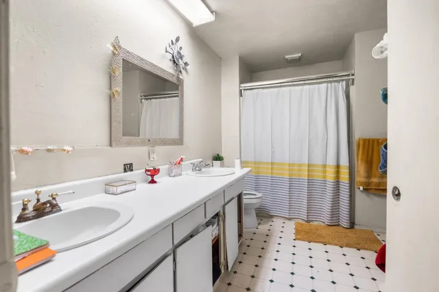 a bathroom with a sink double vanity and a shower