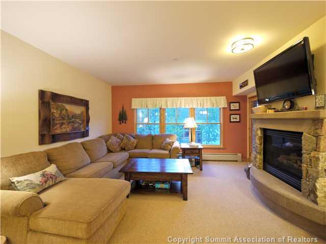 195 River Run Road, Unit 8005 Keystone, CO 80435 - Photo 11 of 12 a living room with furniture a flat screen tv and a fireplace