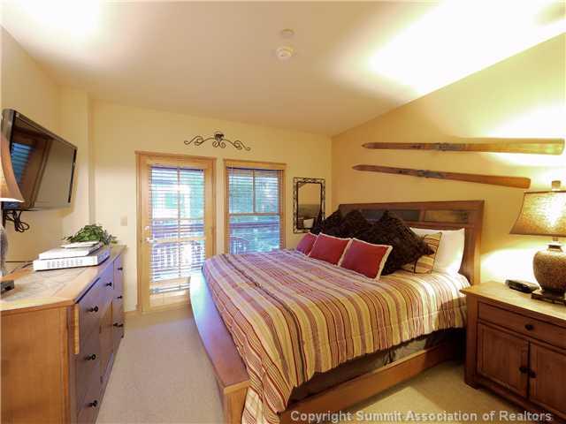 195 River Run Road, Unit 8005 Keystone, CO 80435 - Photo 4 of 12 a bedroom with a bed and a flat screen tv