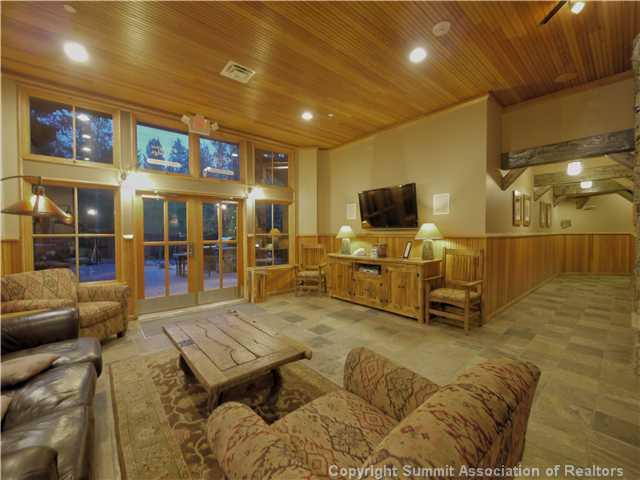 195 River Run Road, Unit 8005 Keystone, CO 80435 - Photo 10 of 12 a living room with couches a flat screen tv and kitchen view